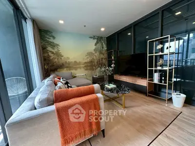 Modern living room with stylish decor and large windows offering natural light.