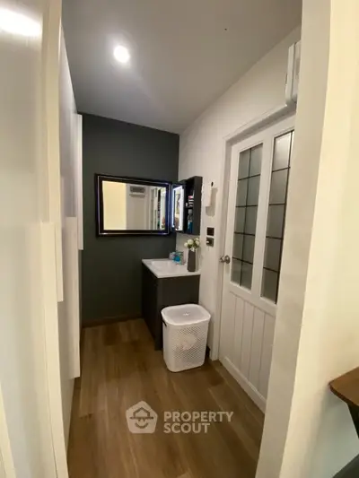 Chic bathroom with modern vanity and stylish decor in a cozy apartment.