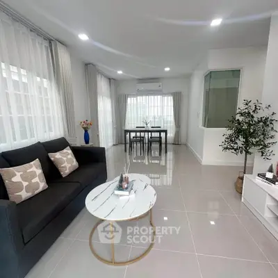 Modern living room with sleek furniture and natural light, perfect for stylish urban living.