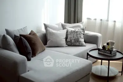Modern living room with stylish gray sectional sofa and chic decor