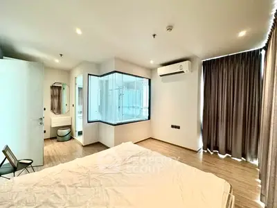 Spacious modern bedroom with ensuite bathroom and natural light