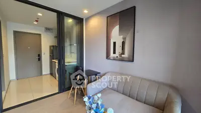 Modern living room with stylish decor and open kitchen layout in a contemporary apartment.