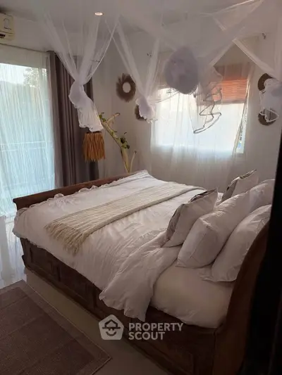 Cozy bedroom with elegant decor and natural light, featuring a comfortable bed and stylish curtains.