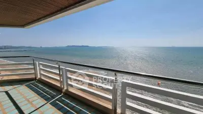 Stunning oceanfront balcony with panoramic sea views and modern railing.