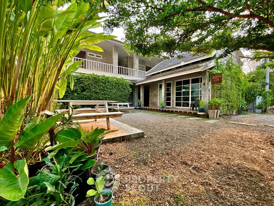 Charming rustic home with lush garden and spacious outdoor seating area, perfect for nature lovers.