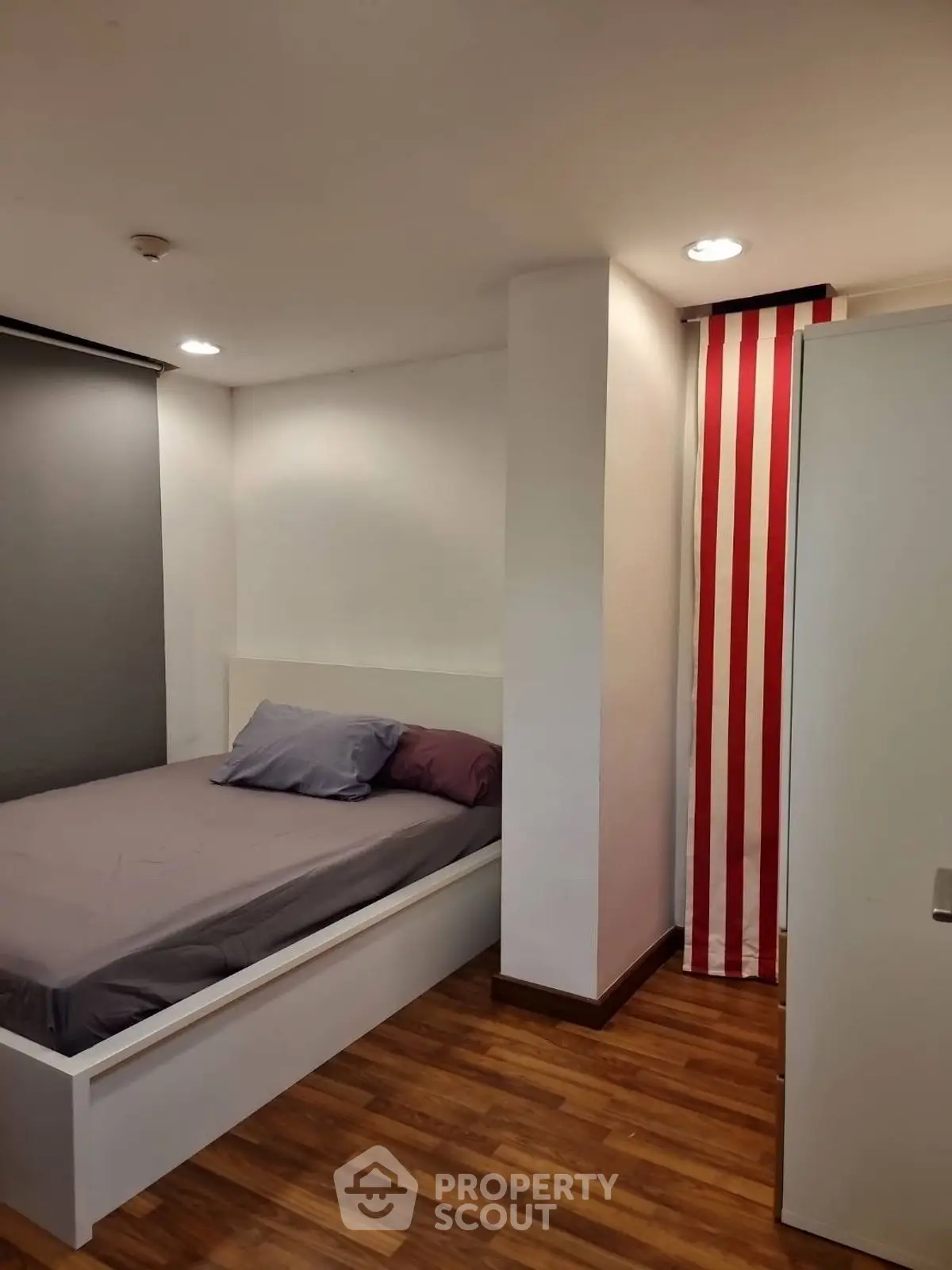 Cozy bedroom with modern decor and wooden flooring