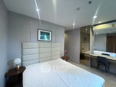 Modern bedroom with stylish decor and ample natural light, featuring a comfortable bed and elegant furnishings.
