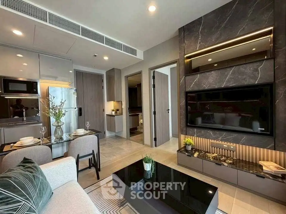 Modern living room with sleek kitchen and stylish decor