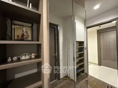 Modern apartment hallway with stylish shelving and mirror closet