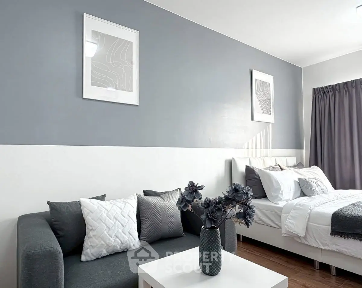 Modern bedroom with stylish decor and cozy seating area