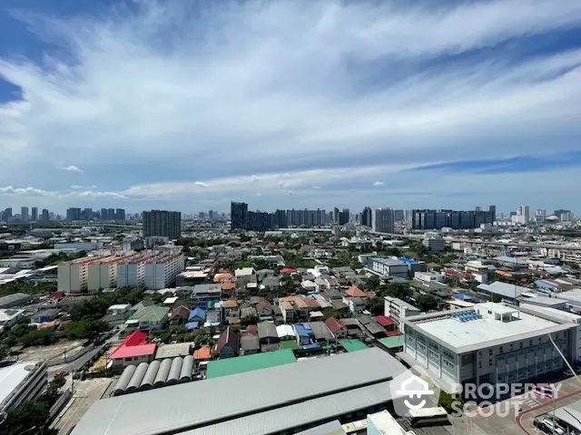 Stunning cityscape view showcasing urban skyline and residential areas under a vibrant blue sky.