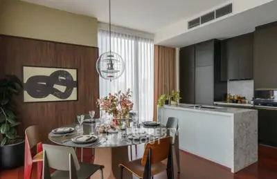 Modern dining area with stylish decor and open kitchen layout in luxury apartment.