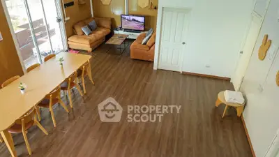 Spacious living room with modern decor and large dining area
