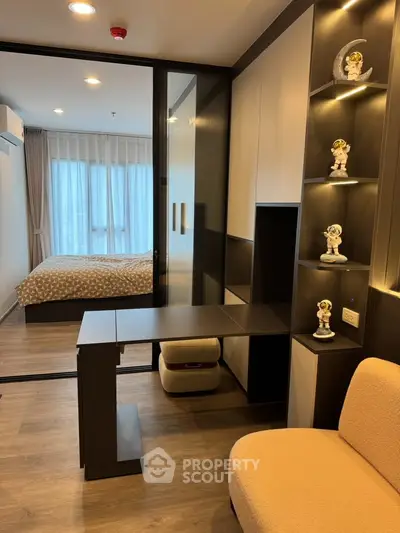 Modern bedroom with stylish decor and built-in shelving in a cozy apartment.