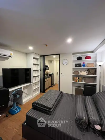 Modern bedroom with stylish decor and ample storage in urban apartment