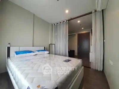 Modern bedroom with minimalist design and comfortable bed in a stylish apartment.