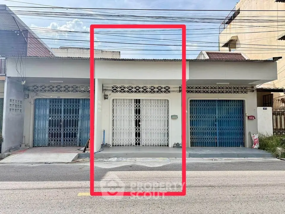 Charming single-story building with secure gated entrance and ample parking space.