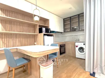 Modern kitchen with integrated appliances and stylish dining area