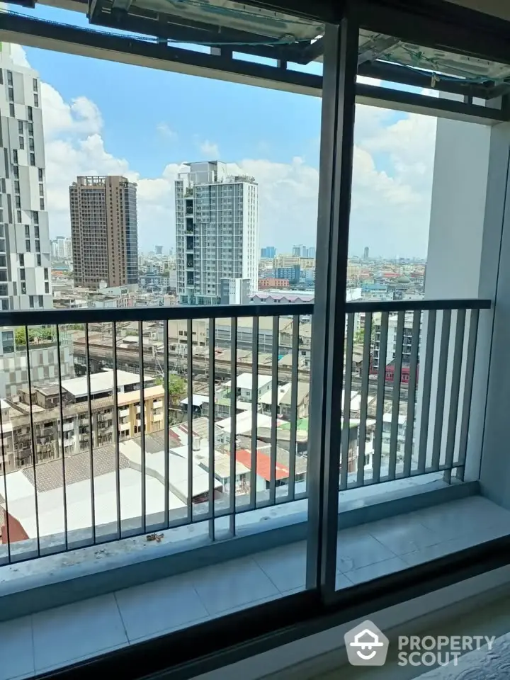 Stunning city view from high-rise balcony with modern railing and skyline backdrop.