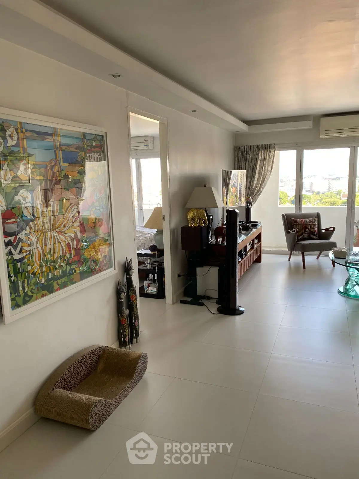 Spacious living room with modern decor and large windows offering natural light.