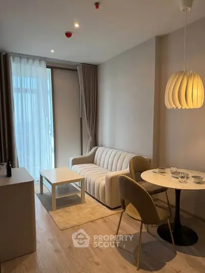 Modern living room with cozy sofa and dining area in stylish apartment