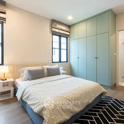 Modern bedroom with stylish decor and ample natural light