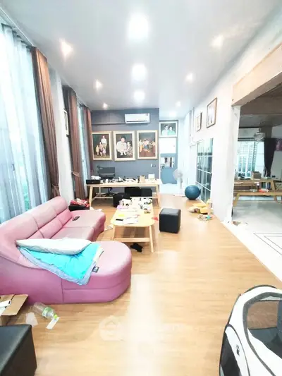 Spacious living room with modern decor and large windows for natural light.