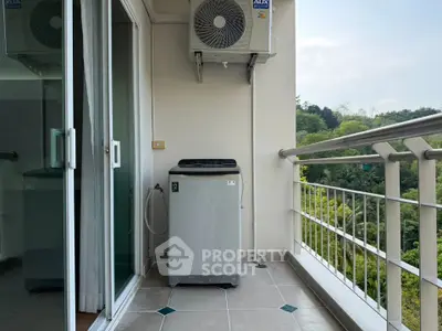 Charming balcony with scenic view and modern washing machine setup, perfect for urban living.