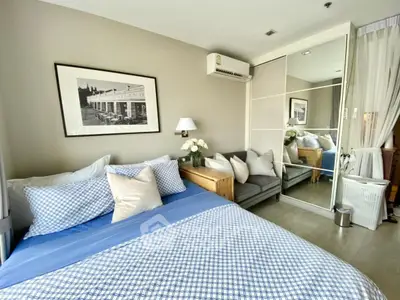 Cozy bedroom with modern decor and mirrored closet doors