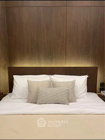 Luxurious bedroom with elegant wood paneling and plush bedding