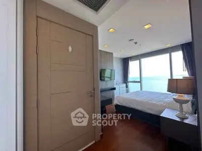 Luxurious bedroom with ocean view, modern furnishings, and natural light.