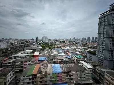 Stunning cityscape view from high-rise building showcasing urban skyline and colorful rooftops.
