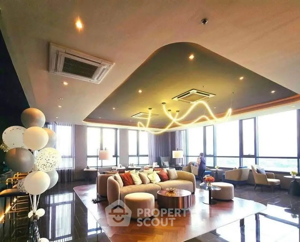 Luxurious and spacious living room with modern decor and stunning city views.