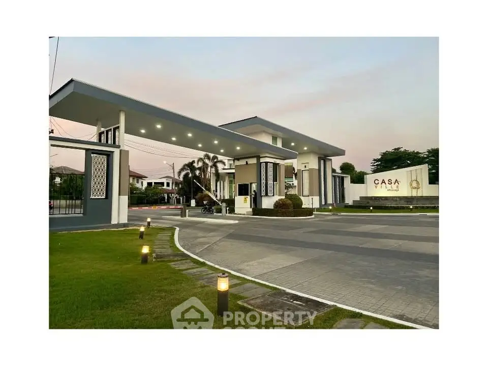 Elegant entrance of Casa Ville with modern architecture and lush greenery