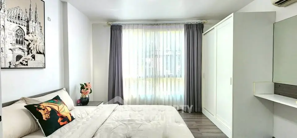 Bright and modern bedroom with stylish decor and ample natural light.