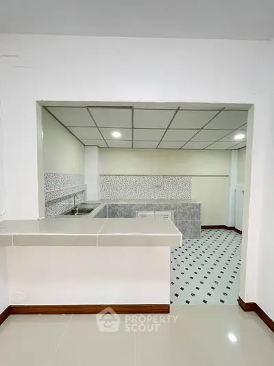 Spacious kitchen with open layout and modern tiled backsplash