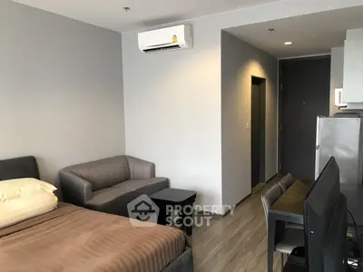 Modern studio apartment with sleek furnishings and air conditioning, perfect for urban living.