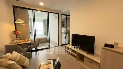 Modern open-plan living room with cozy dining area and view into bedroom