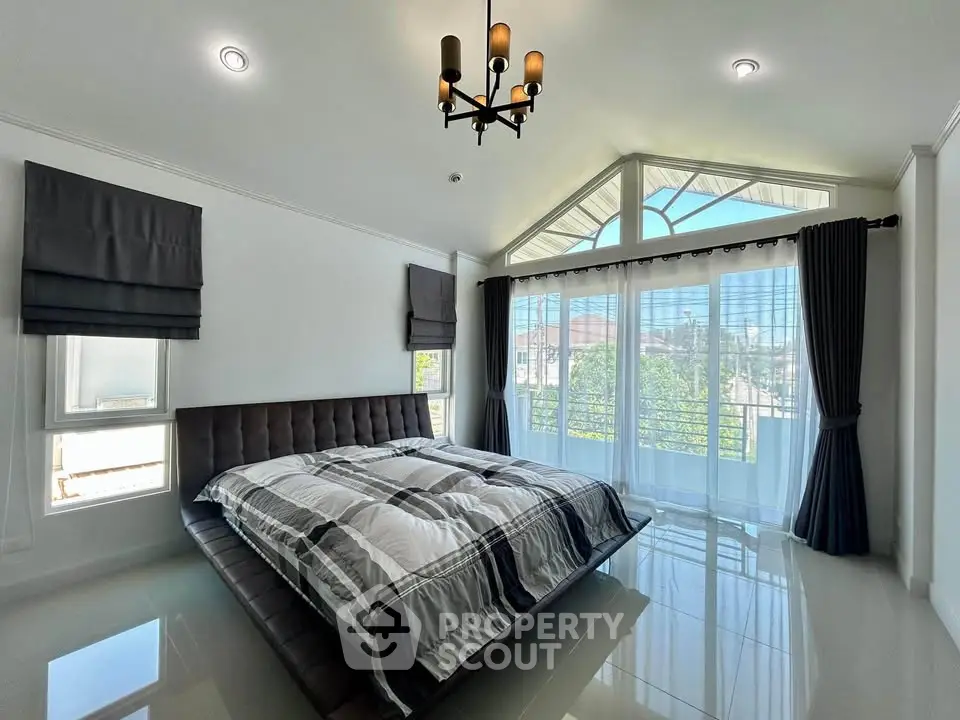 Spacious modern bedroom with large windows and stylish decor