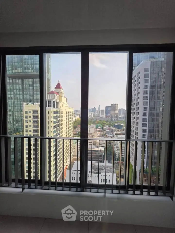 Stunning cityscape view from high-rise apartment window, showcasing urban skyline and modern architecture.
