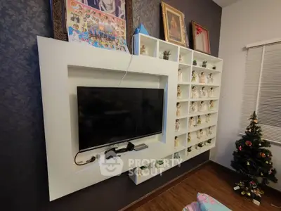 Stylish living room with modern TV setup and decorative shelving