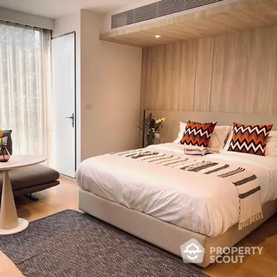 Modern bedroom with stylish wooden wall paneling, plush king-sized bed, and elegant sheer curtains for a cozy, upscale living experience.