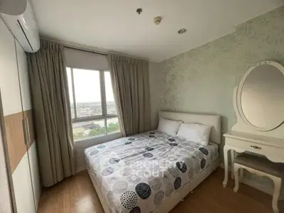 Cozy bedroom with elegant decor and city view, perfect for relaxation.