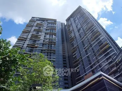 Stunning modern high-rise building with sleek architecture and lush greenery, perfect for urban living.