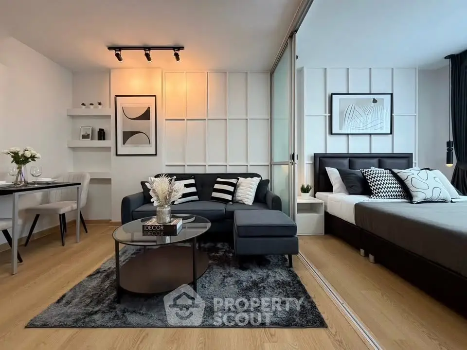 Modern open-plan living room and bedroom with stylish decor and cozy ambiance.