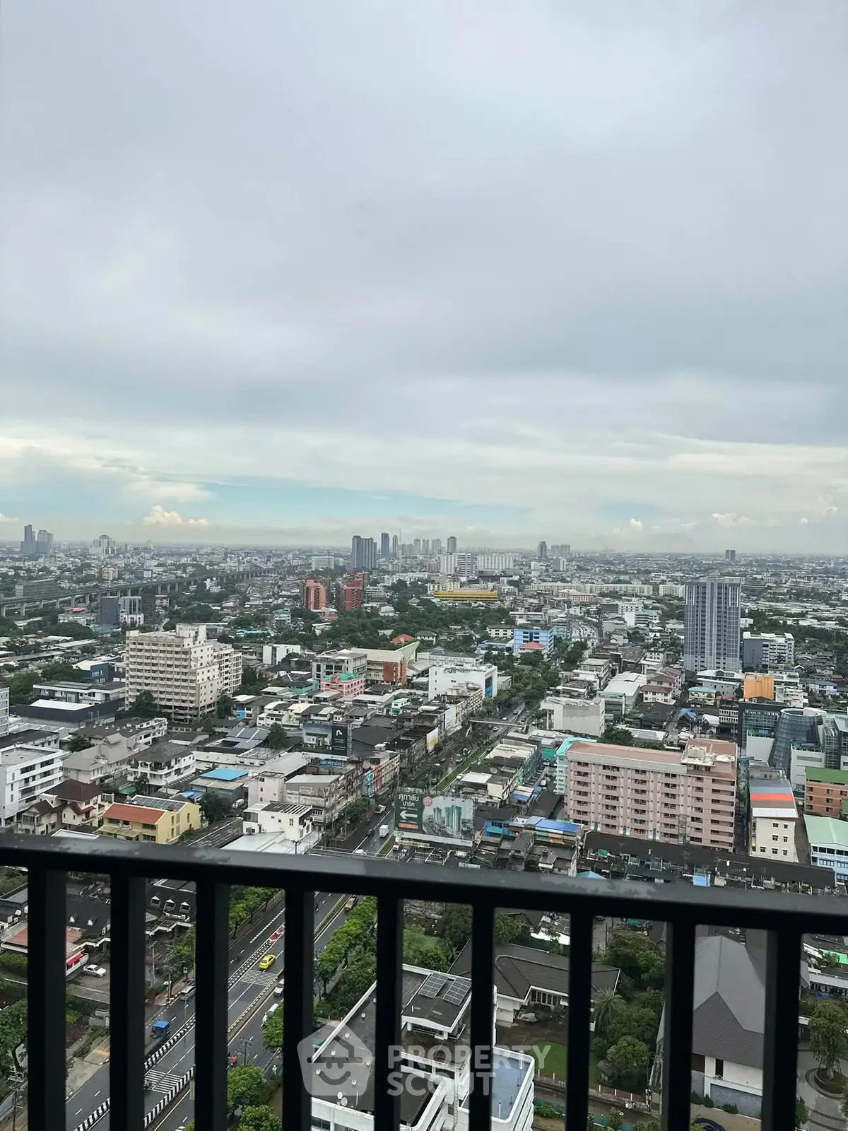 Stunning cityscape view from a high-rise balcony, showcasing urban skyline and expansive horizon.
