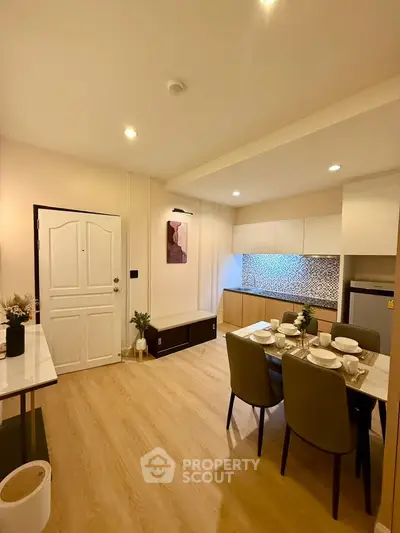 Modern dining area with stylish kitchen in open layout apartment