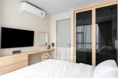 Modern bedroom with sleek design, featuring a wall-mounted TV and air conditioning for ultimate comfort.