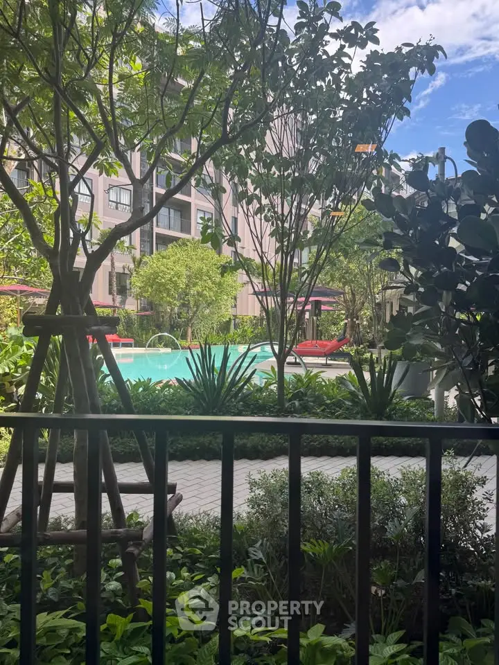 Luxurious apartment complex with lush garden and inviting pool area, perfect for relaxation and leisure.