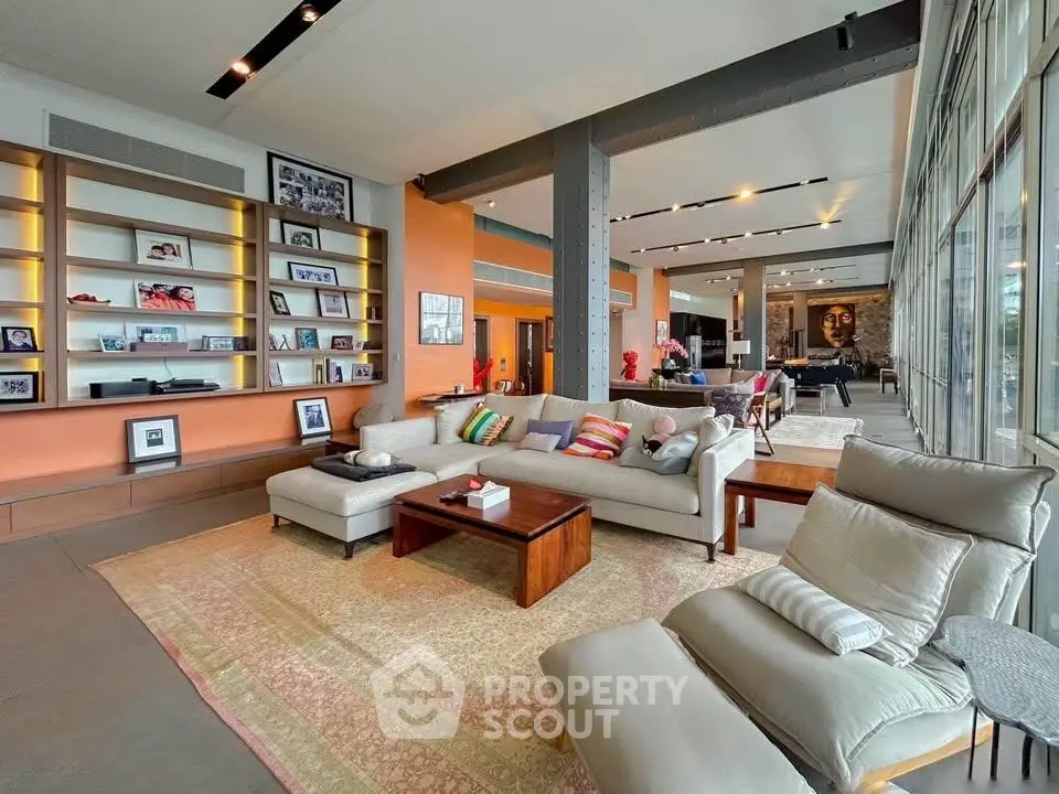 Spacious modern living room with stylish decor and large windows
